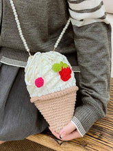 Sweeten up your style with the Vanilla Soft Serve Crocheted Crossbody Bag. This charming, handmade bag is a must-have for those who love unique accessories and kawaii cuteness. Crafted with care, it features a soft serve ice cream design in creamy vanilla crochet, with delightful crocheted strawberry and cherries on the drawstring closure. Whether you're out for a fun day with friends or just looking to add a touch of sweetness to your outfit, this bag is sure to turn heads.